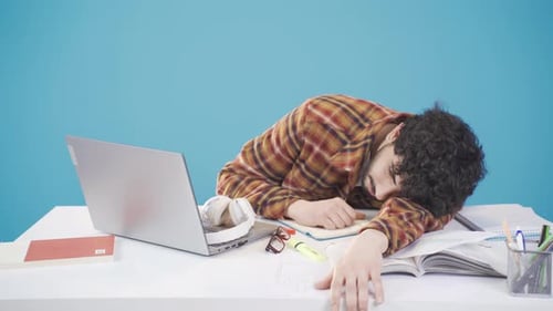 A young college student who is in exam week or doing homework.