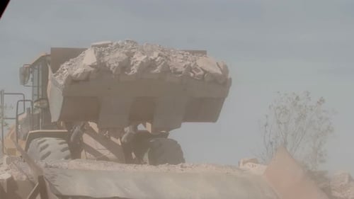 Heavy Equipment Dumps Load of Rocks