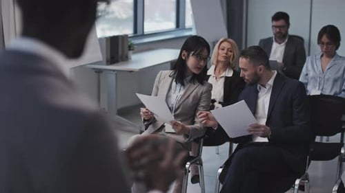 Diverse Group Listens to Speaker at Business Meeting