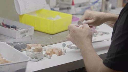 Technician Shapes Dental Prosthetic with Rotary Tool