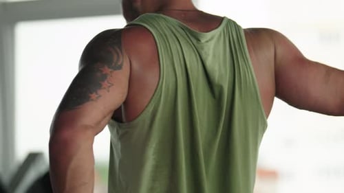 Muscular Man Working Out in Gym