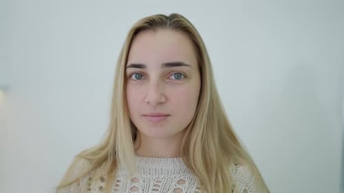 Close-up of Young Woman with Blond Hair Indoors