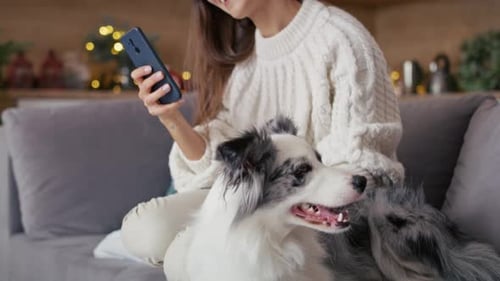 Young Woman Relaxing at Home with Her Dog