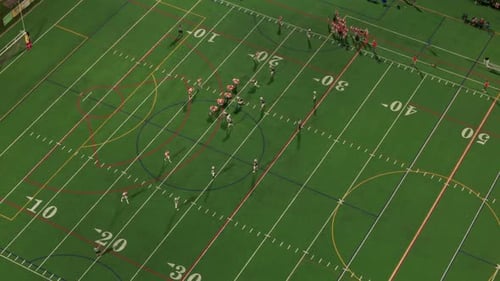 Aerial Shot of American Football Teams of Play at Night Time