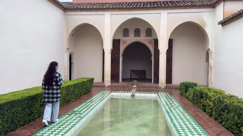 Alcazaba palatial fortification in Málaga Spain young woman tourist inside