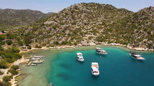 Beautiful view of the beach with boats, pure nature, sea and ships. Shot from a drone.