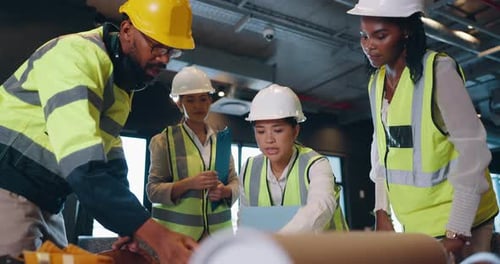 Construction Workers Discussing Project Plan in Workplace