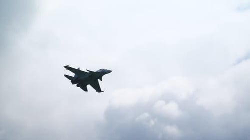 Fighter Jet Flying Through Cloudy Sky During Daytime