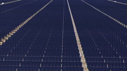 Rows of solar panels stretching across a field, capturing sunlight for renewable energy