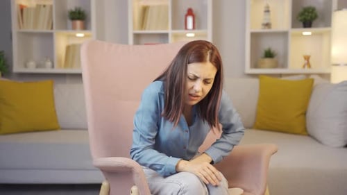Young woman experiencing pain in bones.
