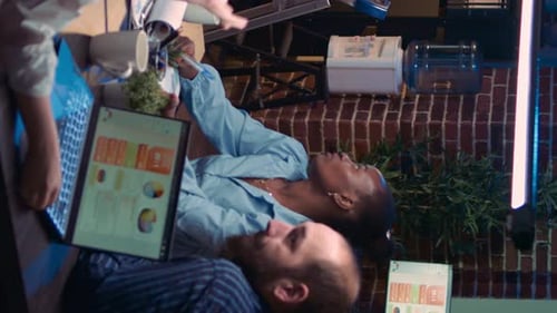 Business Team Analyzing Data at Night in Office