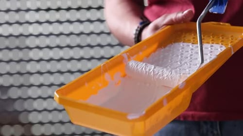 Girl Painting With White Paint And Roller
