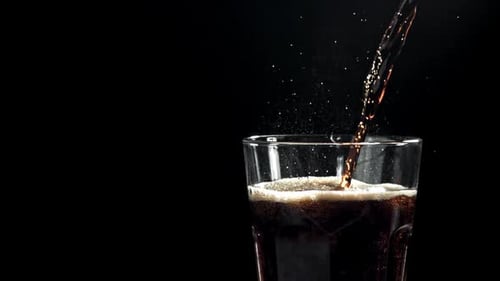 Dark Liquid Being Poured Into Clear Glass