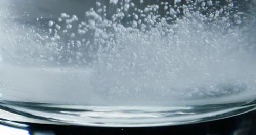 Effervescent Tablet Dissolving in a Glass of Water