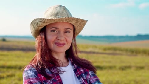 Portrait of a Smiling Female Farmer in a Hat in Field of Cereals In the Sun Light Woman Posing After
