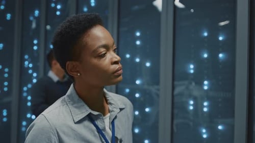 Young Adult Woman Working With a Tablet in Server Room