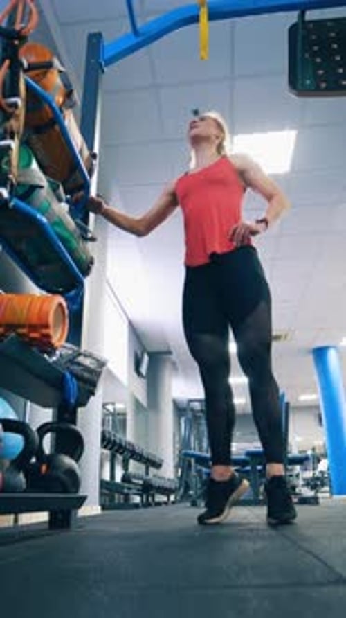 Girl doing exercise in sports gym.