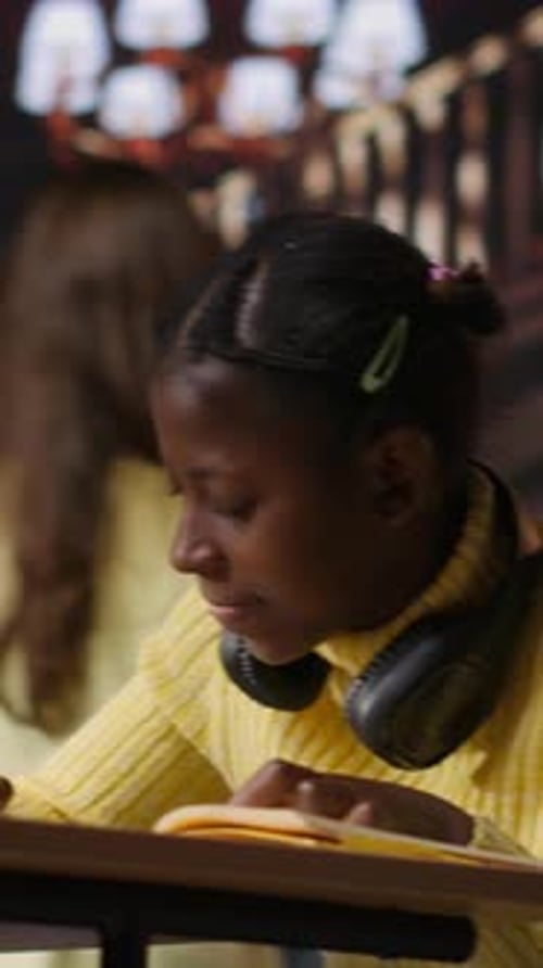 Vertical Video African American Schoolgirl Using Fluorescent Pen to Highlight Key Words