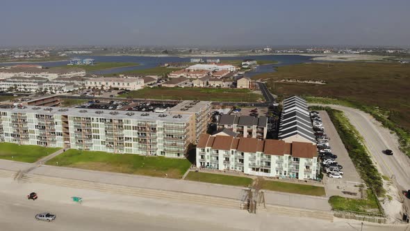 Pan left of the lodging of the inlet channel showing vehicles driving ...