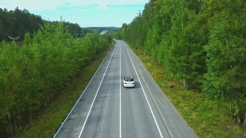 Flying Over the Rural Road and Driving Cabriolet Car Footage Traveling in the Countryside Through