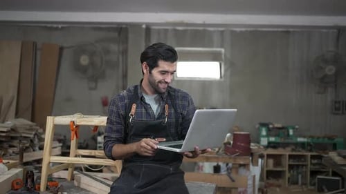 Carpenter is working at workshop.