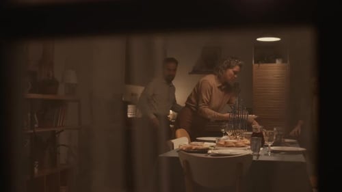 Jewish Family Preparing for Hanukkah Dinner, Seen from Street