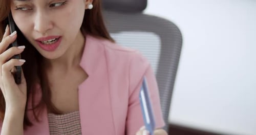 Young Adult Woman on Phone with Credit Card