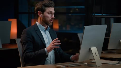 Man Attends Virtual Meeting From His Desk