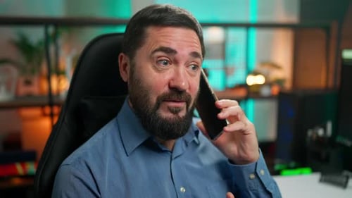 Man in Office Talking on Smartphone