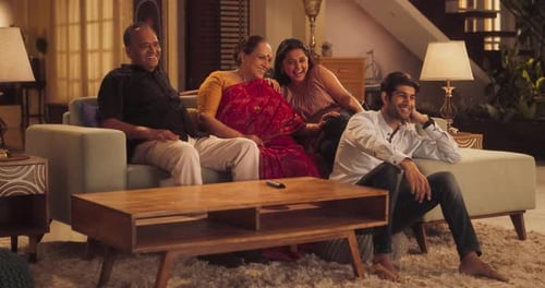 Family Relaxing and Watching Television in Living Room