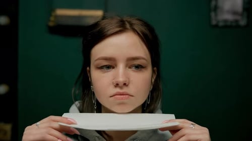 Piercing studio interior - piercing master makes piercing to girl, septum nose piercing