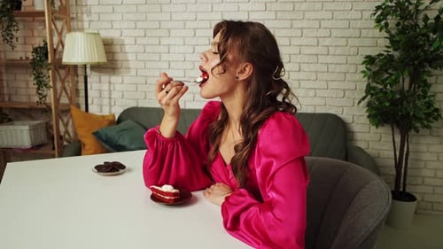 Woman Enjoying Cake and Chocolate Indoors