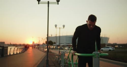 Young Athlete Working Out Doing Triceps Dips on a Street Sports Ground at Sunset
