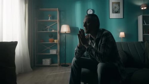 A Devastated Lonely Young Man Sits in a Room in the Dark Going Through a Crisis The Man Thinks Does