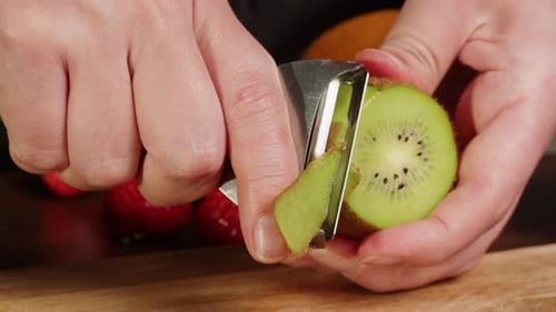 Fresh Kiwi Being Peeled