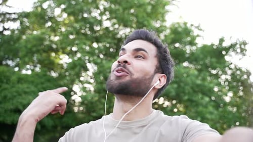 Young Man Talking to Camera in Park