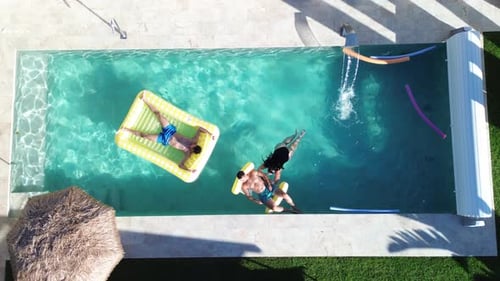 Friends at swimming pool aerial drone view of people that swim at pool floating over inflatable bed