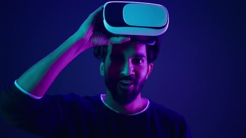 Young Man Removing VR Headset and Smiling