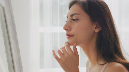 Woman Checking Herself in the Mirror