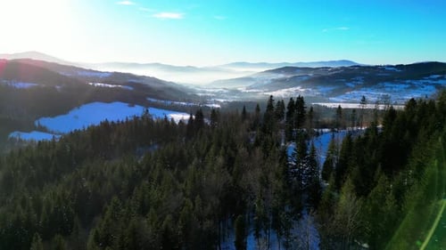 Winter landscape in frosty snow-covered mountains - aerial 4K