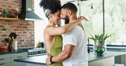 Couple Embracing Affectionately in Modern Kitchen