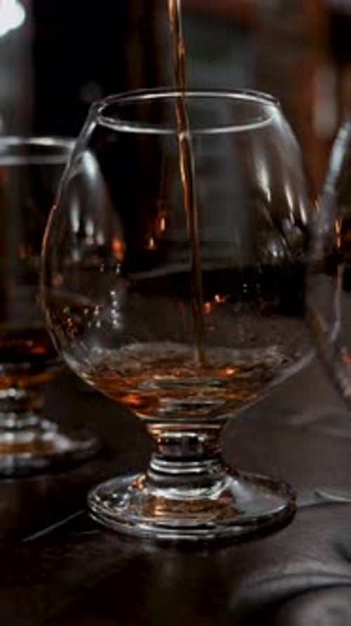 Cognac Is Poured Into A Glass