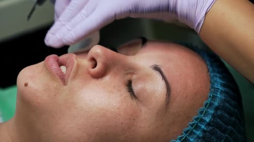 Woman Receiving Facial Treatment at a Clinic