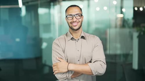 Confident Professional Man Smiling in Modern Office