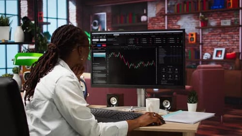 Woman Works at Computer in Home Office Setting