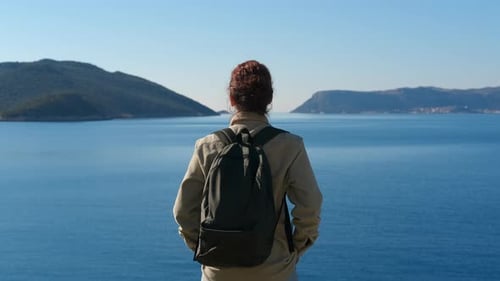 Tourist Watching Inspiring Panorama of Calm Blue Sea and Islands