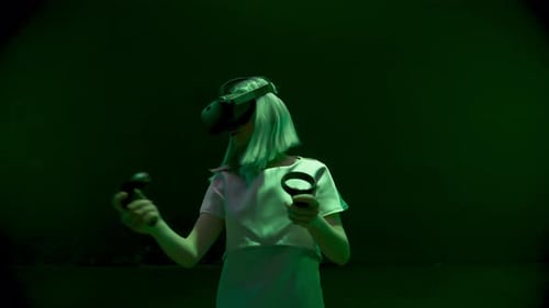 Woman Using VR Headset With Controllers