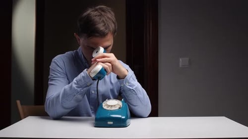 Person with Vintage Phone Worry Man Exhibits Anxiety While Holding Oldfashioned Telephone in Sad