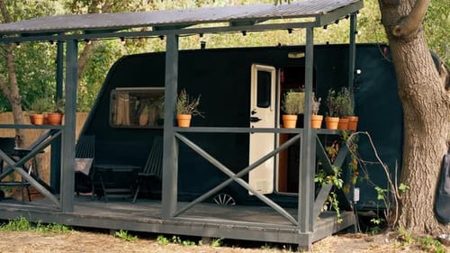 A mobile home with a terrace is located in country glamping site for relaxation and solitude nature