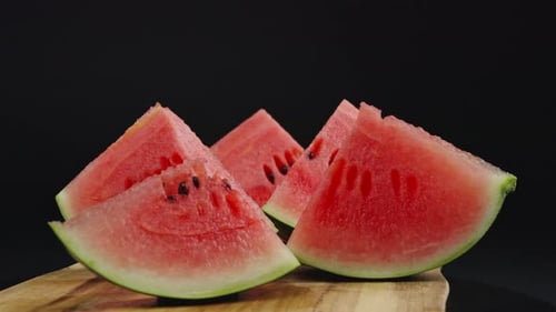 Watermelon Slices Arranged On Wooden Board With Black Background